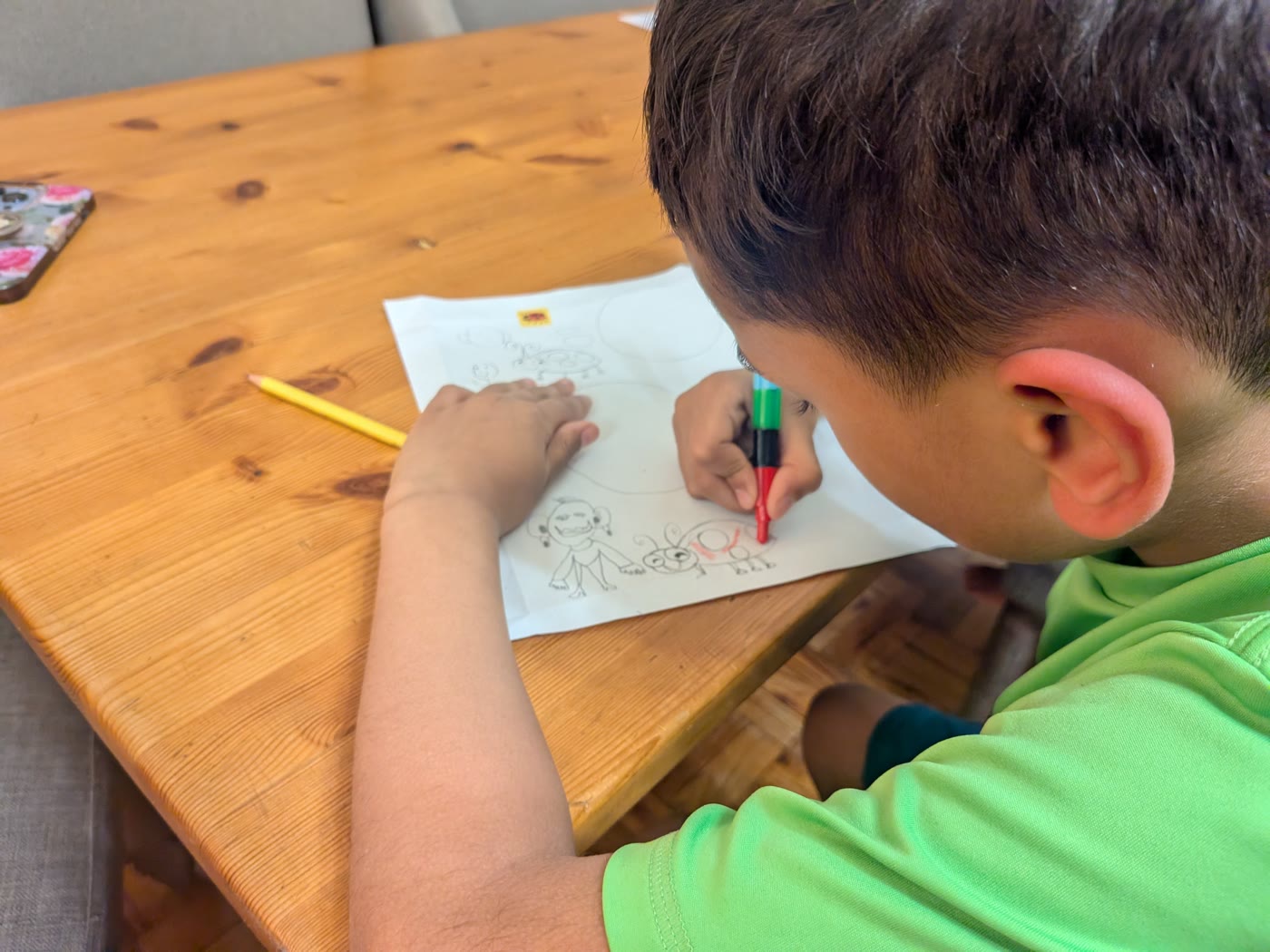 Niam, age 7, writing a letter at the kitchen table